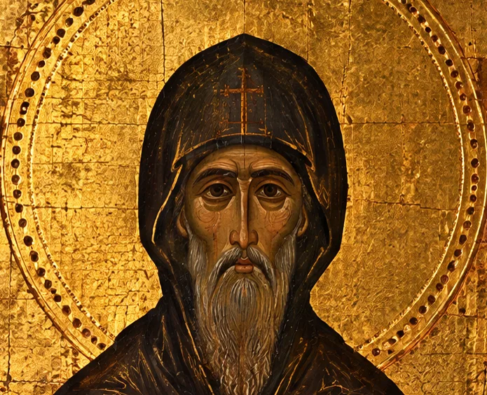 The monk's face: long, bearded and hooded, with large calm eyes
